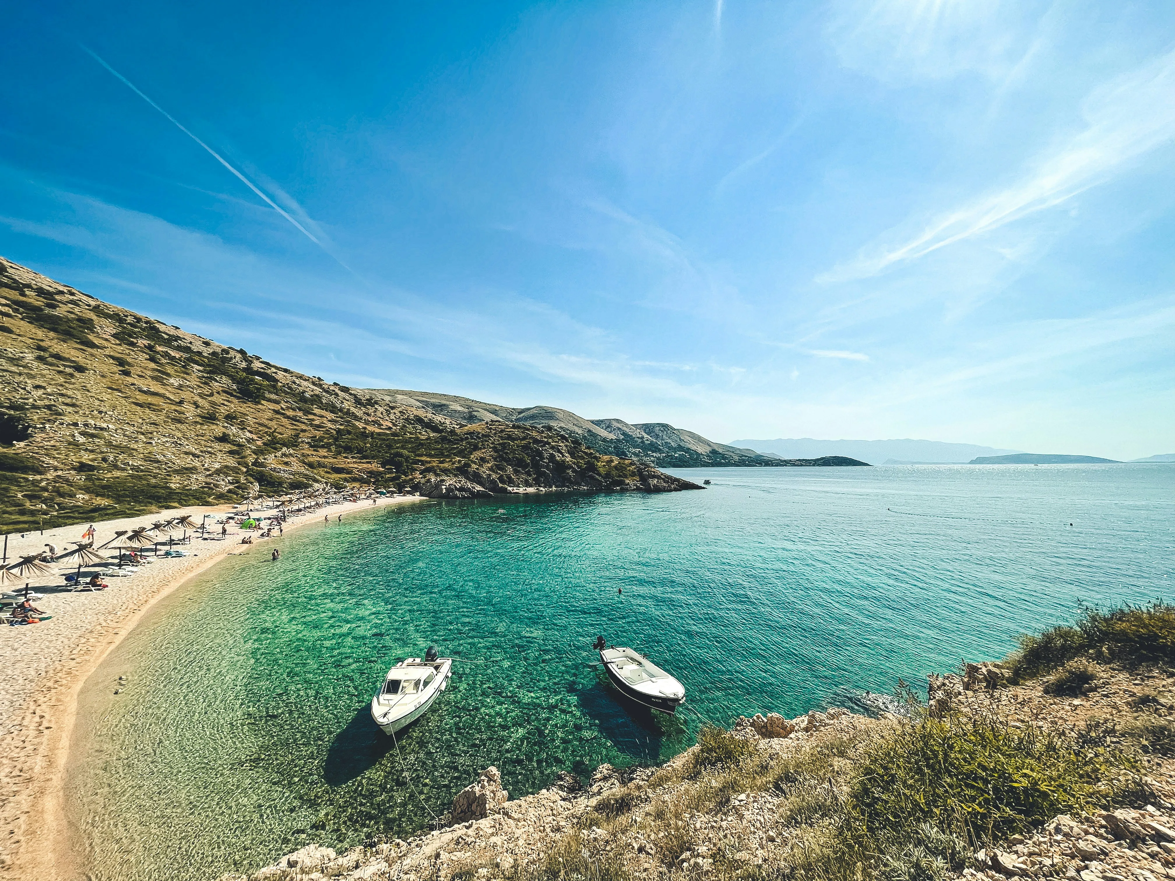 Crystal clear Adriatic cove with pebble beach and pine trees on Krk Island